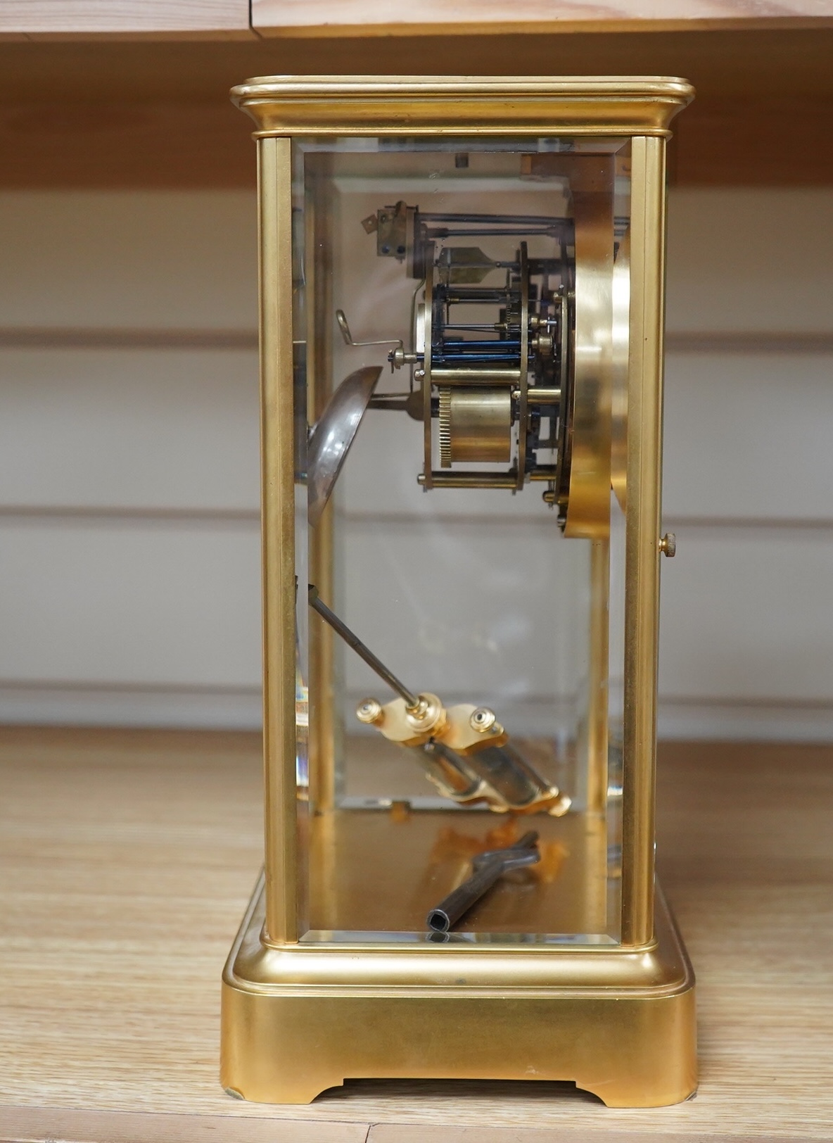 A late 19th century French gilt brass four glass clock, with visible Brocot escapement, key and pendulum, 29.5cm tall. Condition - fair, cracks to dial, not tested